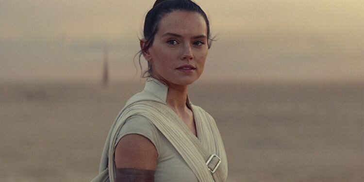 A young white woman stood against a desert backdrop.