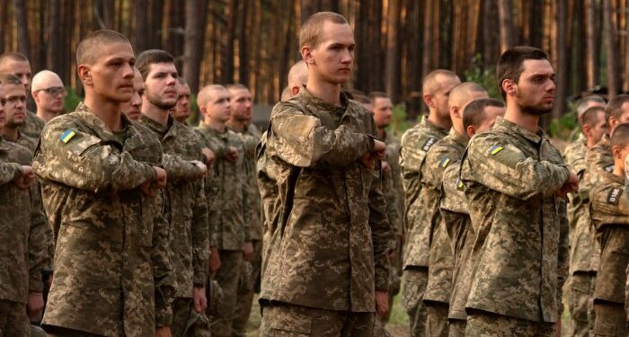 Newly recruited soldiers of Ukraine’s 3rd Assault Brigade line up at a military base close to Kyiv