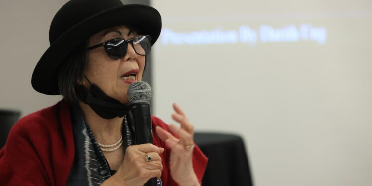 A woman speaks into a microphone