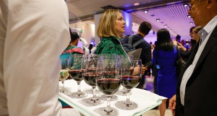 A waiter serves wine during the Welcome Reception ahead of the World Economic Forum (WEF) in Davos, Switzerland