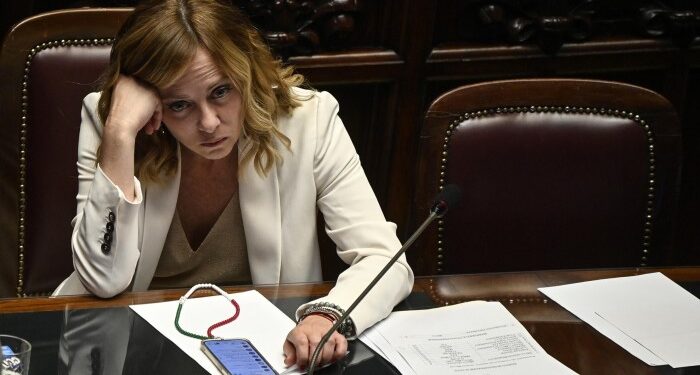 Giorgia Meloni rests her head on her hand in the Italian parliament