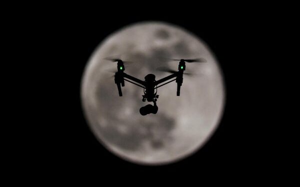 Drone in front of full moon.