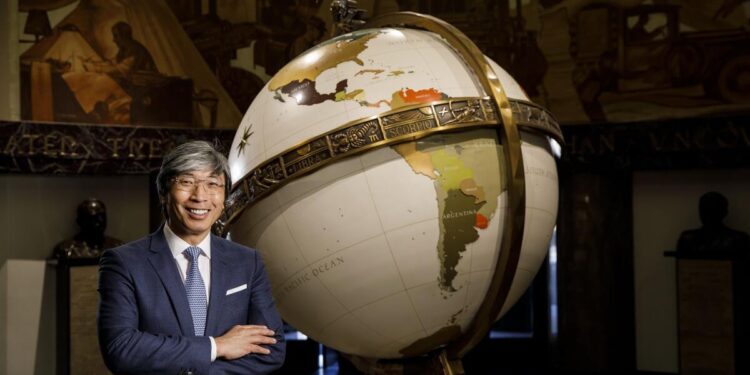 Patrick Soon-Shiong next to the globe in the old L.A. Times building