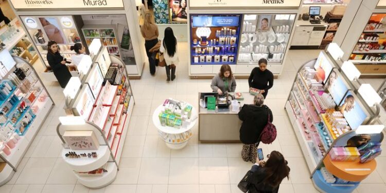 © Reuters. FILE PHOTO: People visit the beauty department at the John Lewis retail store on Oxford Street in London, Britain, October 24, 2024. REUTERS/Hollie Adams/File Photo