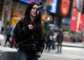 © Reuters. A woman makes a video with a mobile phone to post on TikTok as she stands in Times Square in New York City, New York, U.S., March 13, 2024. REUTERS/Mike Segar/File Photo