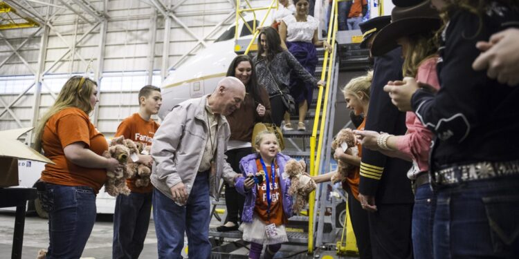 United fantasy flight takes more than 100 kids to visit Santa in Denver airport hangar transformed into the North Pole